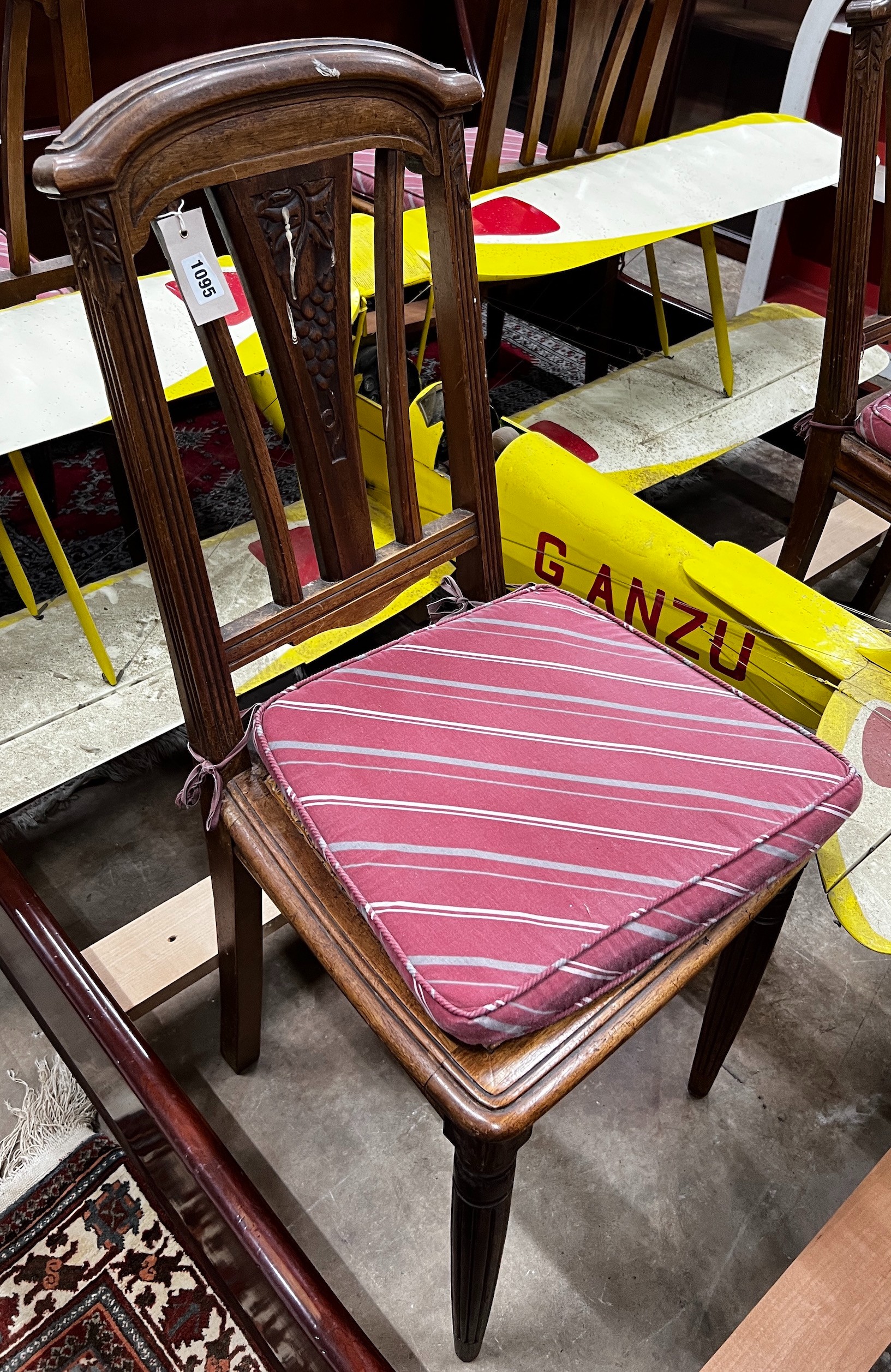 A set of four early 20th century French walnut dining chairs